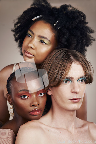 Image of Cosmetic, beauty and young people in studio with creativity, makeup and facial art aesthetic. Lgbtq, diversity and creative man and women models with face cosmetology isolated by a brown background.