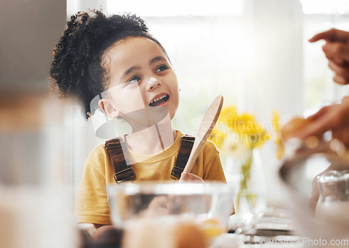 Image of Child in kitchen, baking and learning with parent, wooden spoon and cake flour on face, little baker making breakfast or cookies. Cooking, food and happy boy in home with mixing bowl, tools and smile