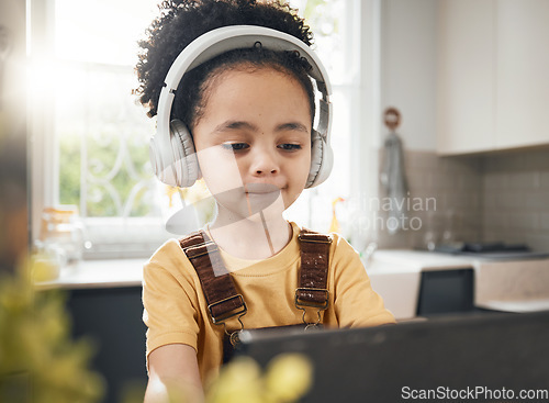 Image of Tablet, headphones and kid in online education in home, elearning or homeschool in kitchen. Serious, technology and boy child on video call, study on internet and listening to music in virtual class