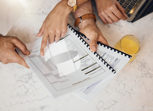 Image of Hands, documents and a couple in the kitchen to budget for finance, investment or savings in a home from above. Paper, insurance or planning with a husband and wife reading information for accounting