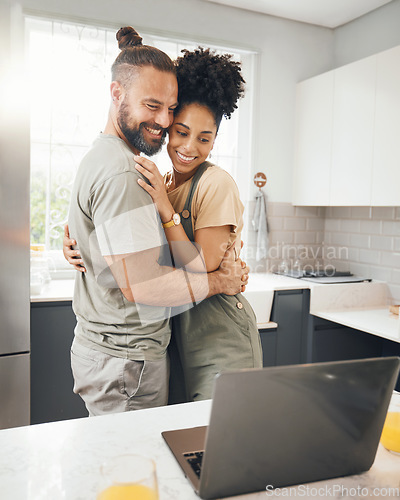 Image of Couple, laptop and hug in home kitchen for influencer post, social media or streaming connection. Interracial man and woman love, care or support for network, internet or communication on technology