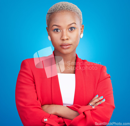 Image of Beauty, crossed arms and serious black woman in a studio with cosmetic, self care and facial routine. Makeup, confidence and portrait of African female model with cosmetology face by blue background.