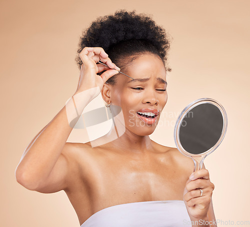 Image of Woman, tweezers and mirror for eyes in studio, beauty or thinking with results, reflection and pain by background. African girl, model and smile for eyebrow removal, inspection and transformation