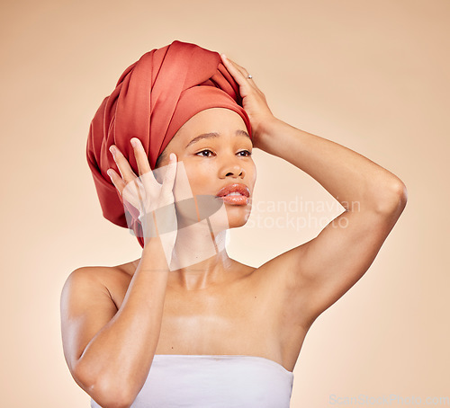 Image of Hair, scarf and black woman in studio for wellness, beauty or natural cosmetics on brown background. Headwrap, pride and African lady model with glowing or skincare satisfaction, results or treatment