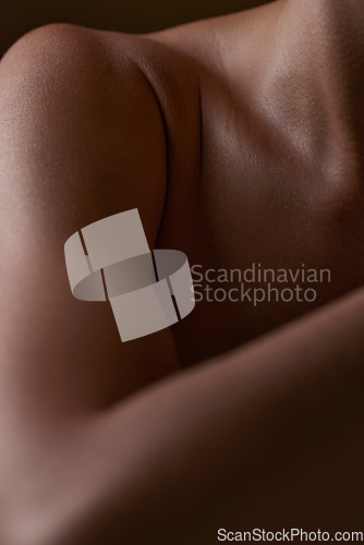 Image of Body, closeup and healthy skin of black woman, shoulder or natural glow from skincare in studio with antiaging cosmetics. Beauty, self care and arm of model with clean, hygiene and aesthetic wellness