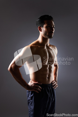 Image of Muscle, body and studio man with fitness challenge results, bodybuilder progress and strong transformation training. Dark shadow, exercise and confident sports athlete thinking on grey background