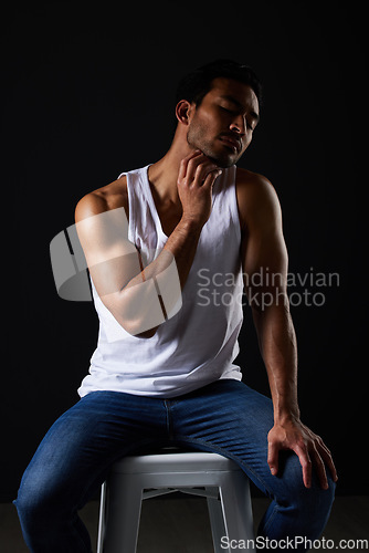 Image of Sexy muscular man on chair in studio with fitness inspiration, beauty aesthetic and sensual fashion. Erotic art, sexual body and male model sitting on black background, thinking in dark lighting.