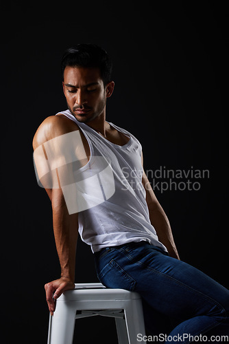 Image of Beauty with sexy, muscular man on chair in studio and fitness inspiration, aesthetic and sensual fashion. Erotic art, sexual body and male model sitting on black background, thinking in dark lighting