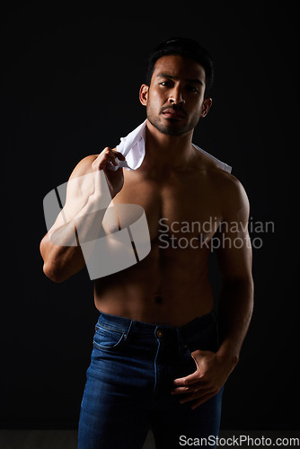 Image of Sexy, muscle and portrait of man in studio with fitness inspiration, beauty aesthetic and sensual fashion. Erotic art, sexual body and male model sitting on black background, topless in dark lighting