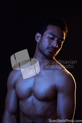 Image of Topless, dark and sexy man on black background in fitness inspiration, beauty aesthetic or strong fantasy. Bodybuilder art, body and seductive male model with muscle, studio and neon blue lighting