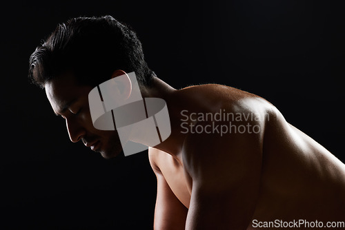 Image of Exercise, strong and studio man doing push up challenge, gym fitness routine and workout for muscle building. Dark shadow light, body training development and calm sports athlete on black background