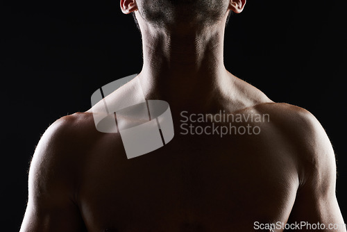 Image of Chest, muscle and man on black background for fitness inspiration, beauty aesthetic or strong body motivation. Shadow aesthetic, male sports model or muscular bodybuilder in dark studio with lighting