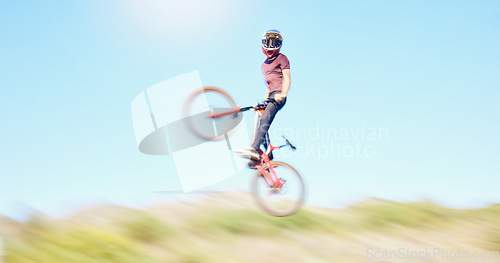 Image of Blur, air and cyclist cycling in nature training for a competition on trail or path in forest or woods. Freedom, wheelie stunt or athlete riding bicycle to jump in cardio exercise, fitness or workout