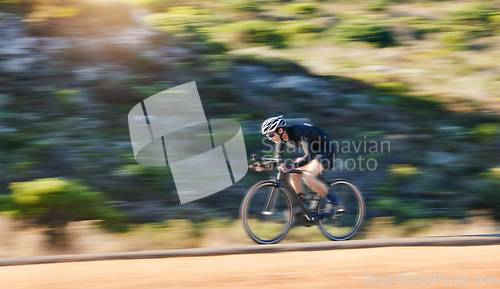 Image of Motion blur, fitness and cyclist on bicycle on road in mountain with helmet, exercise adventure trail and speed. Cycling race, nature and man with bike for fast workout, training motivation or energy