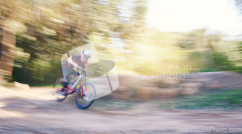 Image of Blur, race and man cycling in nature training for a competition on trail in forest or woods. Action, sports or fast cyclist athlete riding bicycle at speed for cardio exercise, fitness or workout