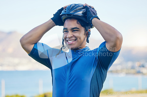 Image of Cycling helmet, exercise and a man outdoor for sports, workout or training with a happy smile. face of a young athlete or cyclist with safety, wellness and fitness at park or thinking of performance