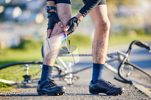 Image of Man, cyclist and legs in knee injury, accident or pain after cycling exercise, fitness or outdoor workout on road. Closeup of male person or biker with sore bruise, inflammation or bicycle fall