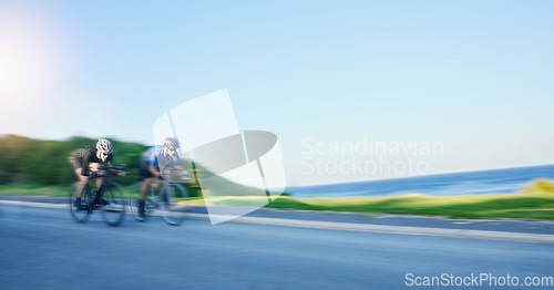 Image of Blur motion, sports and people cycling on bicycle for race, competition or marathon training. Fitness, fast and team of athlete cyclists riding a bike for speed practice on a mountain road in nature.