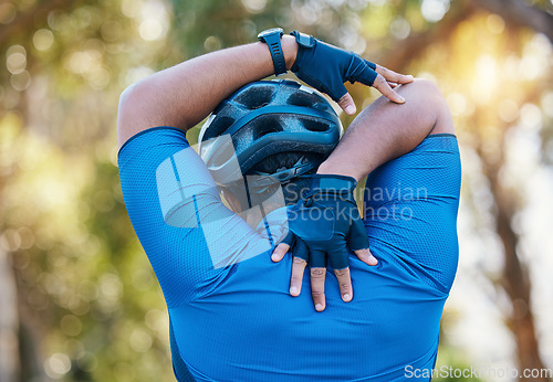 Image of Man, cyclist and stretching arms in nature in sports fitness, workout or outdoor exercise for wellness. Active male person, back or athlete in warm up, cycling or ready for training or adventure