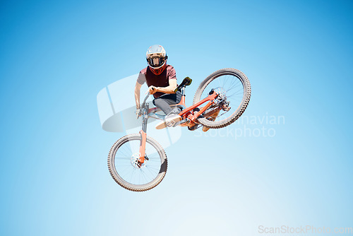 Image of Cycling, sky and a man jump outdoor for sports, workout or training with skills and stunt. Athlete or cyclist with safety, wellness and fitness or performance space with balance and bicycle in air