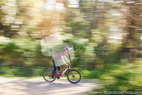 Image of Blurred trees, sports and athlete cycling on bicycle for race, competition or marathon training. Fitness, fast and man cyclist riding a bike for speed practice challenge in mountain forest in nature.