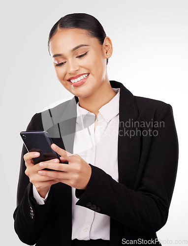 Image of Happy business woman, phone and typing in social media, networking or communication against a studio background. Female person or employee smile in online texting or chatting on mobile smartphone app