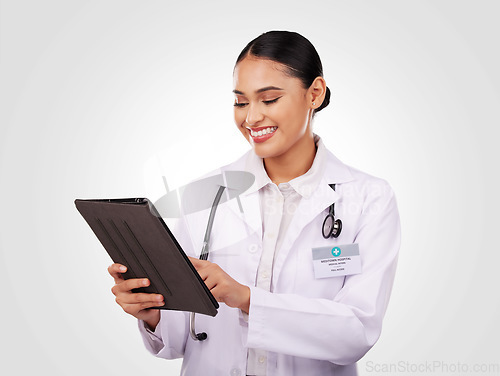 Image of Happy woman, doctor and tablet in healthcare research, communication or Telehealth against a studio background. Female person, nurse or medical professional smile on technology for online networking