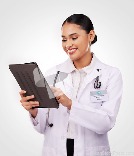 Image of Happy woman, doctor and tablet in medical research, communication or Telehealth against a studio background. Female person, nurse or healthcare professional smile on technology for online networking