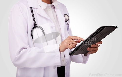 Image of Doctor, hands and tablet in healthcare research, Telehealth or communication against a studio background. Closeup of medical person or professional on technology in online search or clinic results