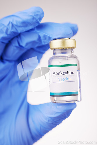 Image of Health, doctor and vaccine in hand, bottle with closeup and safety from monkey pox on white background. Person with glass container, immunity and liquid for healthcare, protect and medicine in studio