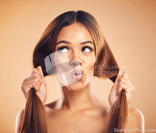 Image of Face pucker, beauty or woman with hair care, healthy shine and strong extensions, volume or keratin results. Hairdressing, facial expression or natural model with studio hairstyle on brown background