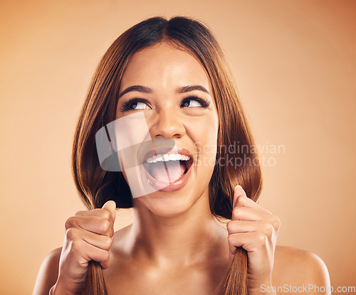 Image of Face, happiness and woman with straight healthy hair, texture shine and strong extensions, volume or highlights. Salon studio, clean hairstyle and face of happy person scream on brown background