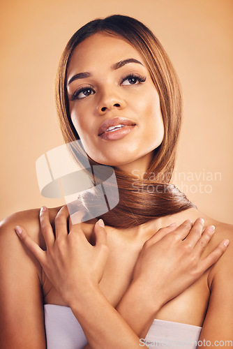 Image of Thinking, hair care and woman with beauty, shine and texture on a brown studio background. Luxury, person and model with grooming routine, natural cosmetics and stylish with glow, aesthetic or volume