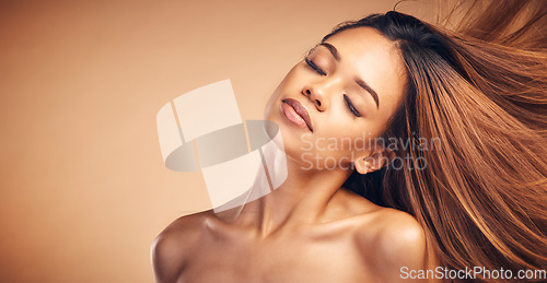 Image of Mockup, beauty and hair with a natural woman in studio on a brown background for keratin treatment. Face, space and shampoo with a confident young model at the salon for growth or aesthetic haircare