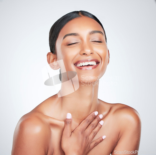 Image of Face, beauty and smile with a woman laughing for health or wellness in studio on white background. Skincare, funny and cosmetics with a young model feeling happy or satisfaction about natural skin