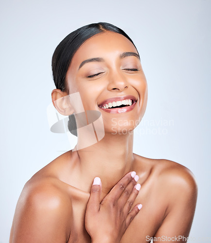 Image of Face, skincare and smile with a woman laughing for health, wellness or dermatology in studio on white background. Skincare. funny and a happy young model feeling satisfaction at her cosmetic routine