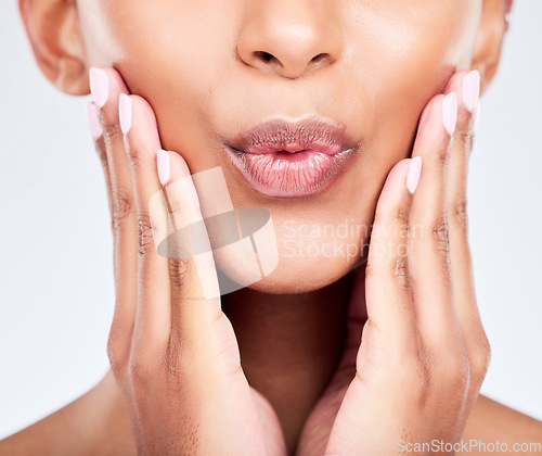 Image of Face, hands and lips with a woman closeup in studio on a white background for beauty, skincare or natural cosmetics. Aesthetic, mouth pout and wellness with a young model touching her healthy skin