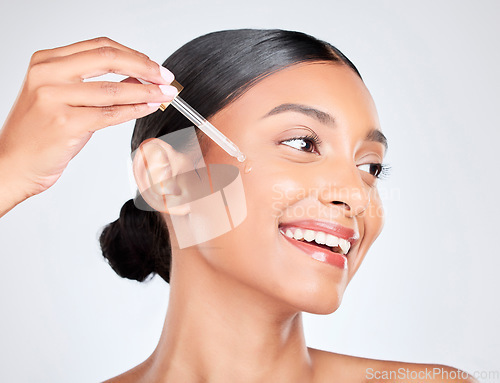 Image of Happy, woman and pipette with skincare, oil and serum for beauty with wellness on white studio background. Person, cosmetic product or model with hyaluronic acid, luxury or shine with serum and glow
