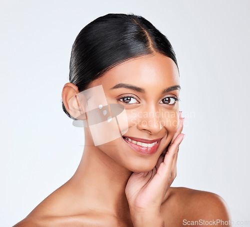 Image of Portrait, cream and woman with skincare, beauty and dermatology on a white studio background. Face, person and model with lotion, shine and glow with cosmetics, moisturiser and smile with aesthetic