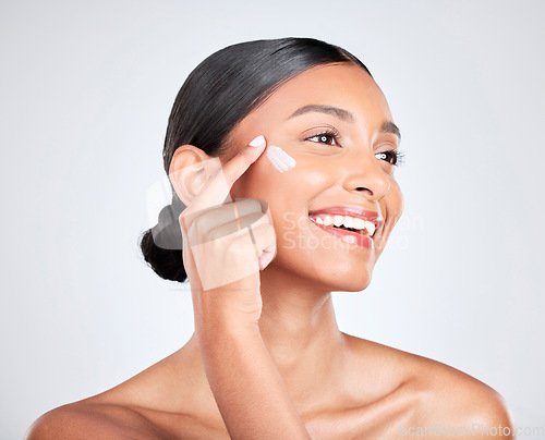 Image of Smile, cream and woman with skincare, cosmetics or dermatology on a white studio background. Person, happy or model with creme, moisturiser or wellness with self care, beauty or aesthetic with lotion