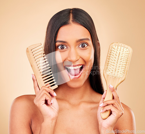 Image of Brush, happy and portrait of woman in studio with clean salon treatment hairstyle for wellness. Beauty, hair care and excited Indian female model with comb for haircut maintenance by brown background