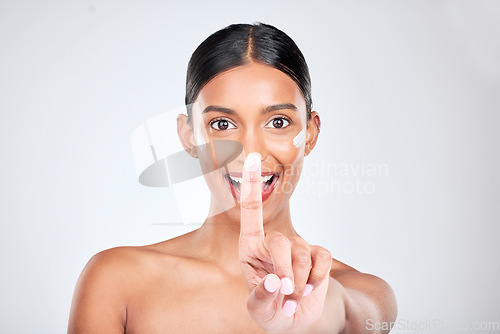 Image of Beauty, skincare and portrait of woman with face cream in a studio for natural, cosmetic and health routine. Happy, wellness and young female model with spf, sunscreen or lotion by a gray background.