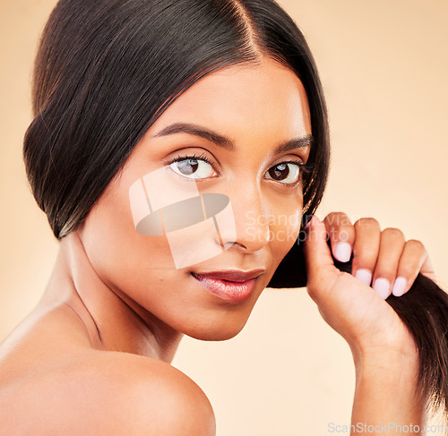 Image of Strong hair, portrait and woman with beauty, self care and glow from collagen in shampoo or cosmetics on studio background. Indian, face and model with haircare, treatment or healthy texture or shine