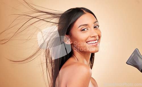 Image of Hair, wind and hairdryer with woman in portrait, keratin treatment and beauty isolated on studio background. Shine, salon hairstyle and haircare with texture, growth and heat with electric appliance