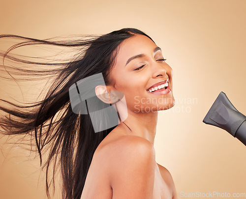 Image of Woman, hair with dryer and wind, beauty and cosmetics tools with shine isolated on studio background. Heat treatment, keratin and wellness with straight hairstyle, electric appliance and growth