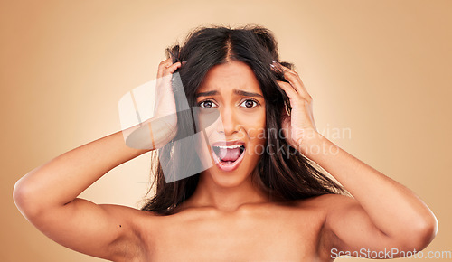 Image of Hair care, portrait and woman stress, frustrated and surprise for treatment disaster at hairdresser. Face, person and girl with scalp problem, volume and hard texture in studio on beige background