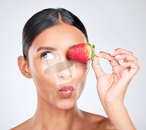 Image of Kiss face, strawberry and woman with beauty, nutrition and health with shine isolated on white background. Fruit, vegan and wellness with eco friendly skincare, natural cosmetics and pout in studio