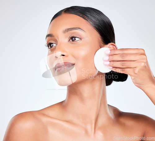 Image of Face, woman and cotton pad, beauty and makeup removal with skincare and clean facial isolated on white background. Hygiene, cosmetics and product with wellness, dermatology and skin shine in a studio