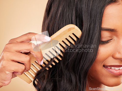 Image of Comb, closeup and young woman in studio with clean salon treatment hairstyle for wellness. Health, hair care and zoom of female model with cosmetic tool for haircut maintenance by brown background.