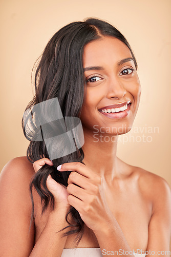Image of Portrait, hair care and woman with beauty, smile and treatment on a brown studio background. Face, person and model with shampoo, style and grooming with aesthetic, wellness and luxury with shine